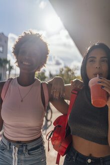 USA, Florida, Miami Beach, two happy female friends having a soft drink in the city - BOYF01166