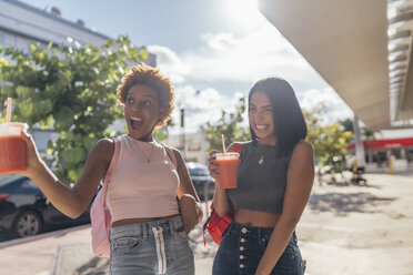 USA, Florida, Miami Beach, two carefree female friends having a soft drink in the city - BOYF01167