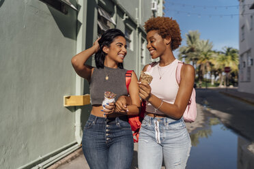 USA, Florida, Miami Beach, two happy female friends with ice cream cones in the city - BOYF01220