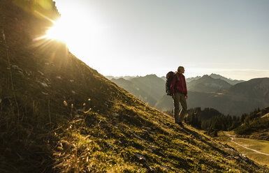 Woman standing in the mountains, enjoying the view - UUF15992