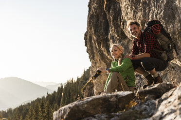 Couple taking a break in the mountains, looking at view - UUF16018