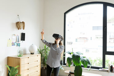 Young woman at home wearing VR glasses - VABF02042