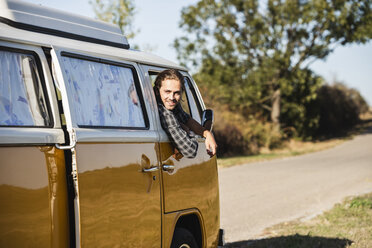 Young man on a road trip with his camper - UUF16137