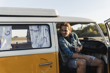 Young man on a road trip with his camper, taking a break - UUF16244