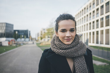 Portrait of smiling woman wearing scarf in autumn - MOEF01860