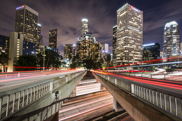 Light trails on bridges in city at night - CAVF57986