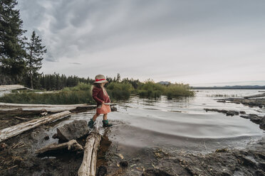 Side view of carefree girl walking in lake against sky - CAVF58174