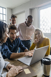 Business team using laptop during a meeting in office - GIOF05023