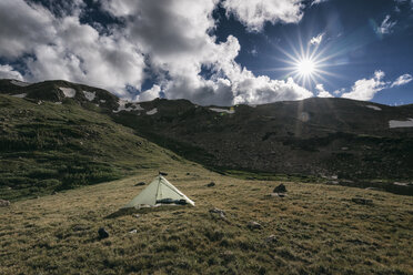 Tent on mountain against cloudy sky during sunny day - CAVF58536