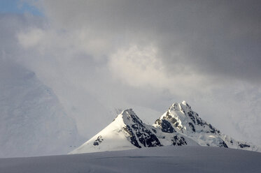 Landschaftliche Ansicht eines schneebedeckten Berges vor bewölktem Himmel - CAVF58697