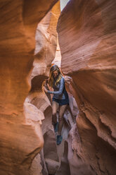 Carefree female hiker amidst canyons - CAVF58868