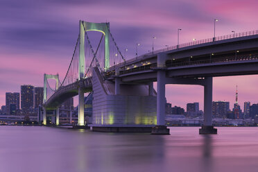 Rainbow bridge and Tokyo tower against sky during sunset - CAVF58961