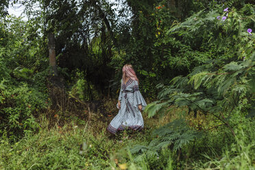 Woman in dress walking at forest - CAVF58988