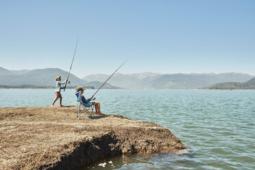 Chile, Talca, Rio Maule, two boys fishing in lake - SSCF00129