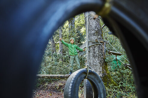 Boy playing at an adventure park in forest - SSCF00153