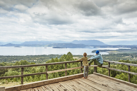 Chile, Puren, Nahuelbuta National Park, woman with son on observation terrace overlooking the lake stock photo