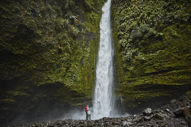 Chile, Patagonia, Osorno Volcano, mother and son standing at Las Cascadas waterfall - SSCF00167