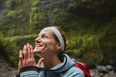 Chile, Patagonia, Osorno Volcano, portrait of woman admiring Las Cascadas waterfall - SSCF00171