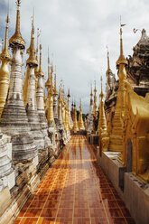 Pathway amidst stupas at Shwe Indein Pagoda against sky - CAVF59246