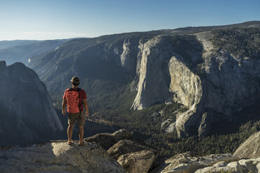 Rückansicht eines männlichen Wanderers, der auf einer Klippe im Yosemite National Park steht - CAVF59387