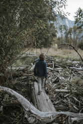 Rear view of brothers walking on log amidst forest at Yosemite National Park - CAVF59619