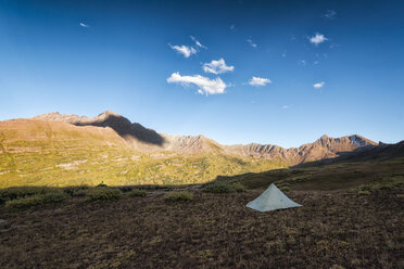 Tent on field against blue sky - CAVF59632