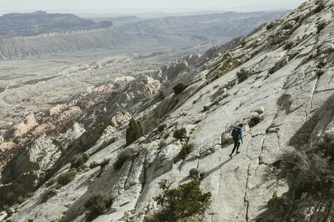 High angle view of hiker walking on mountain against sky stock photo