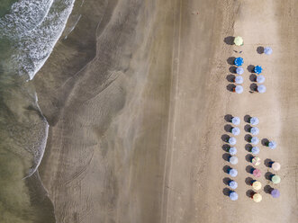 Bali, Kuta Beach, rows of beach umbrellas, aerial view - KNTF02517