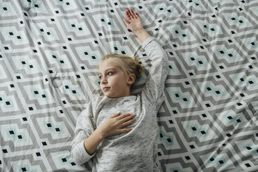 High angle view of thoughtful girl lying on bed - CAVF59747