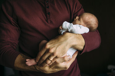 Midsection of father carrying cute sleeping daughter at home - CAVF59755