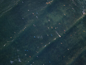 Indonesia, Bali, Canggu, Aerial view of surfers at Batu bologna beach - KNTF02519