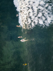 Indonesia, Bali, Canggu, Aerial view of surfers at Batu bologna beach - KNTF02521