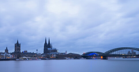 Germany, Cologne, city view with Cologne Cathedral at blue hour - SKAF00069