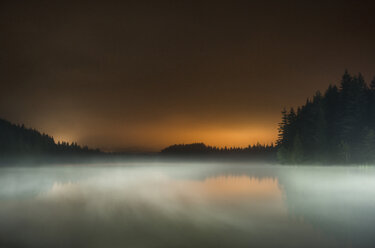 Long exposure of fog over lake at Mt Hood National Forest against sky during sunset - CAVF59851