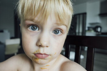 Close-up of portrait of boy sitting on chair at home - CAVF59889