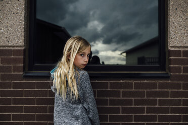 Portrait of girl standing by house - CAVF59918