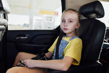Portrait of girl sitting in car - CAVF59950