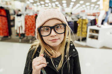 Portrait of girl standing in shopping mall - CAVF59963