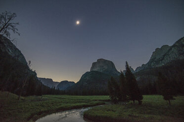 Scenic view of mountains against clear sky in forest at dusk - CAVF59997