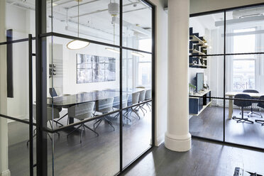 Conference room seen through window in modern office - CAVF60118