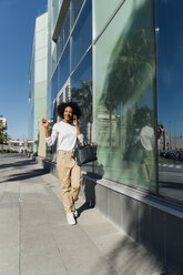 Young casual businesswoman using smartphone in the city - BOYF01242