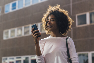 Young casual businesswoman using smartphone in the city - BOYF01257