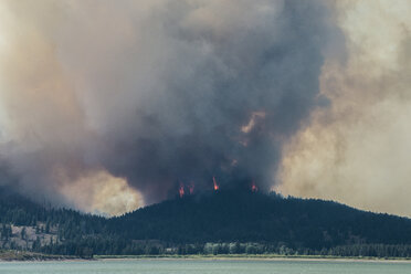 Smoke emitting from mountains during forest fire at Grand Teton National Park - CAVF60351
