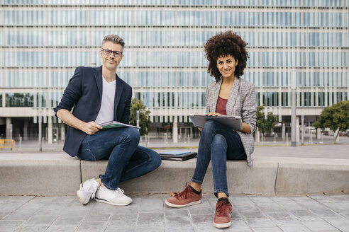 Portrait of two confident colleagues working together outside office building - JRFF02204