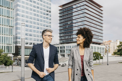 Two happy colleagues talking outside office building - JRFF02207