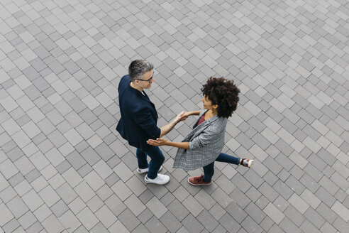 Top view of two colleagues shaking hands on a square - JRFF02214