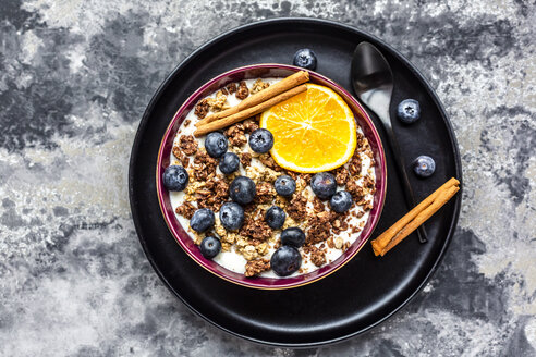 Crunchy muesli with blueberries, slice of orange and cinnamon sticks - SARF04016