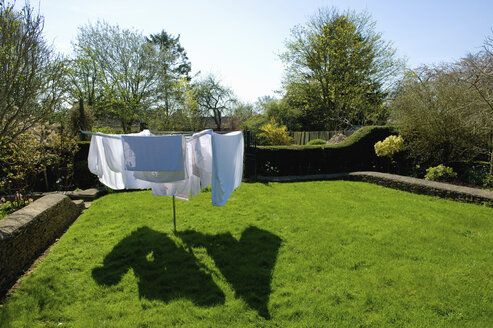 Eine drehbare Wäscheleine mit Wäsche, die auf einem Trockenplatz in der Sonne trocknet. - MINF09807