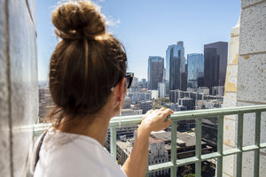 USA, California, Los Angeles, woman looking at the city from observation point - DAWF00836