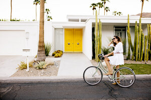 USA, California, Palm Springs, woman on bicycle on the street - DAWF00863